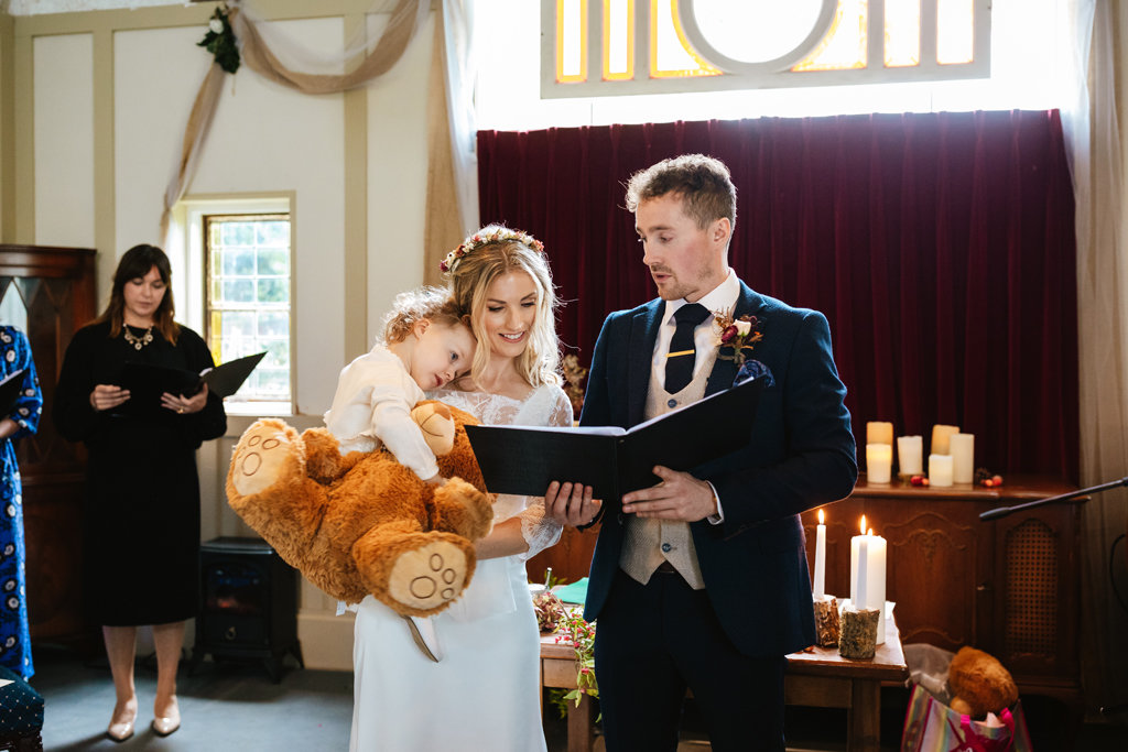 Groom bride baby daughter church