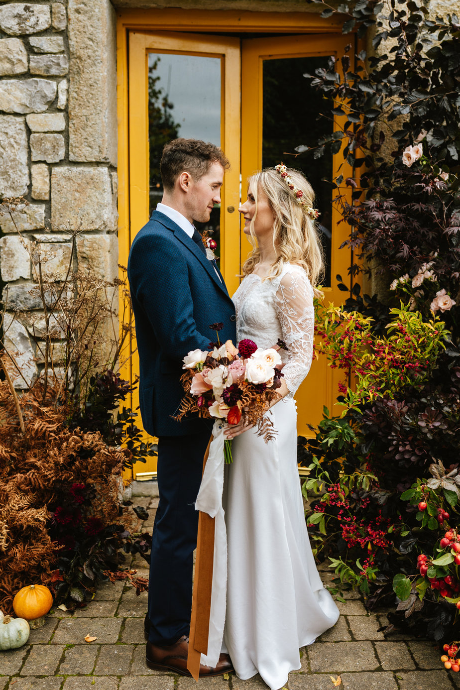 Bride groom lace dress detail embrace flowers bouquet