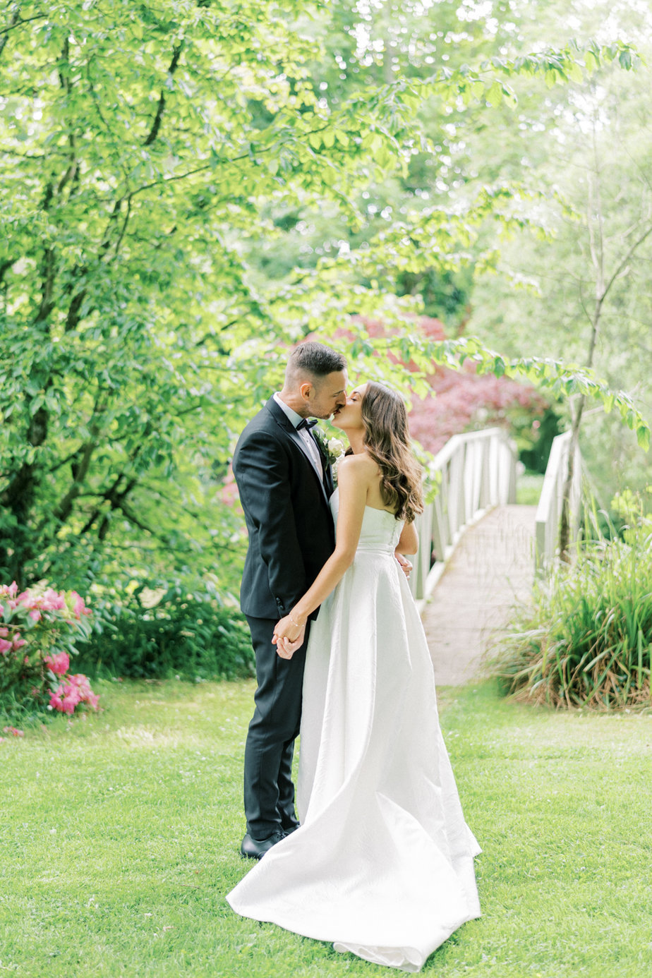 Bride groom white flower bouquet exterior garden kissing kiss