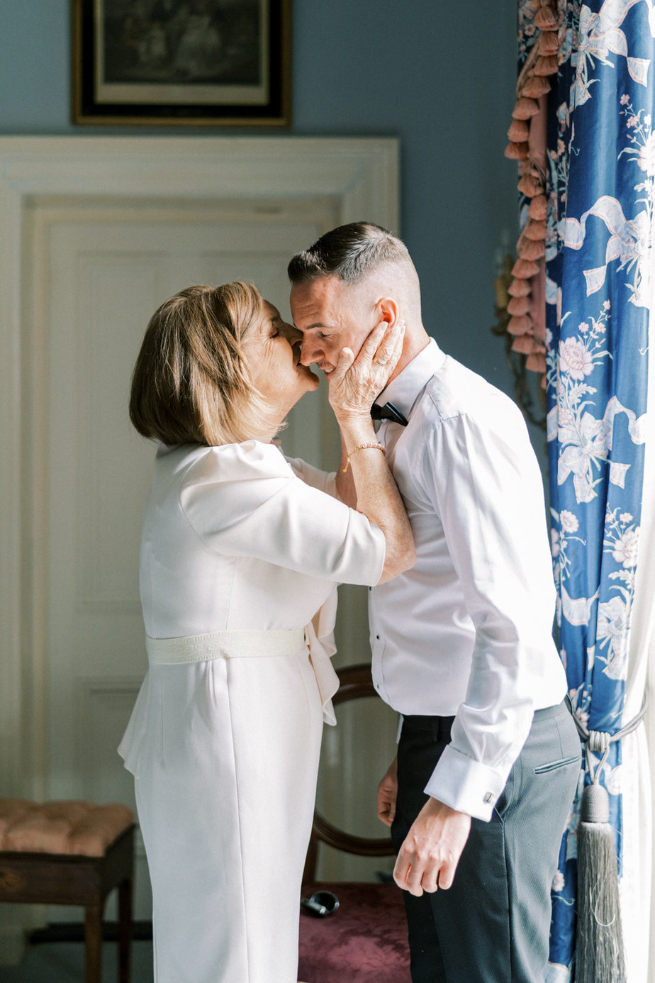 Mother groom getting ready kiss on the cheek