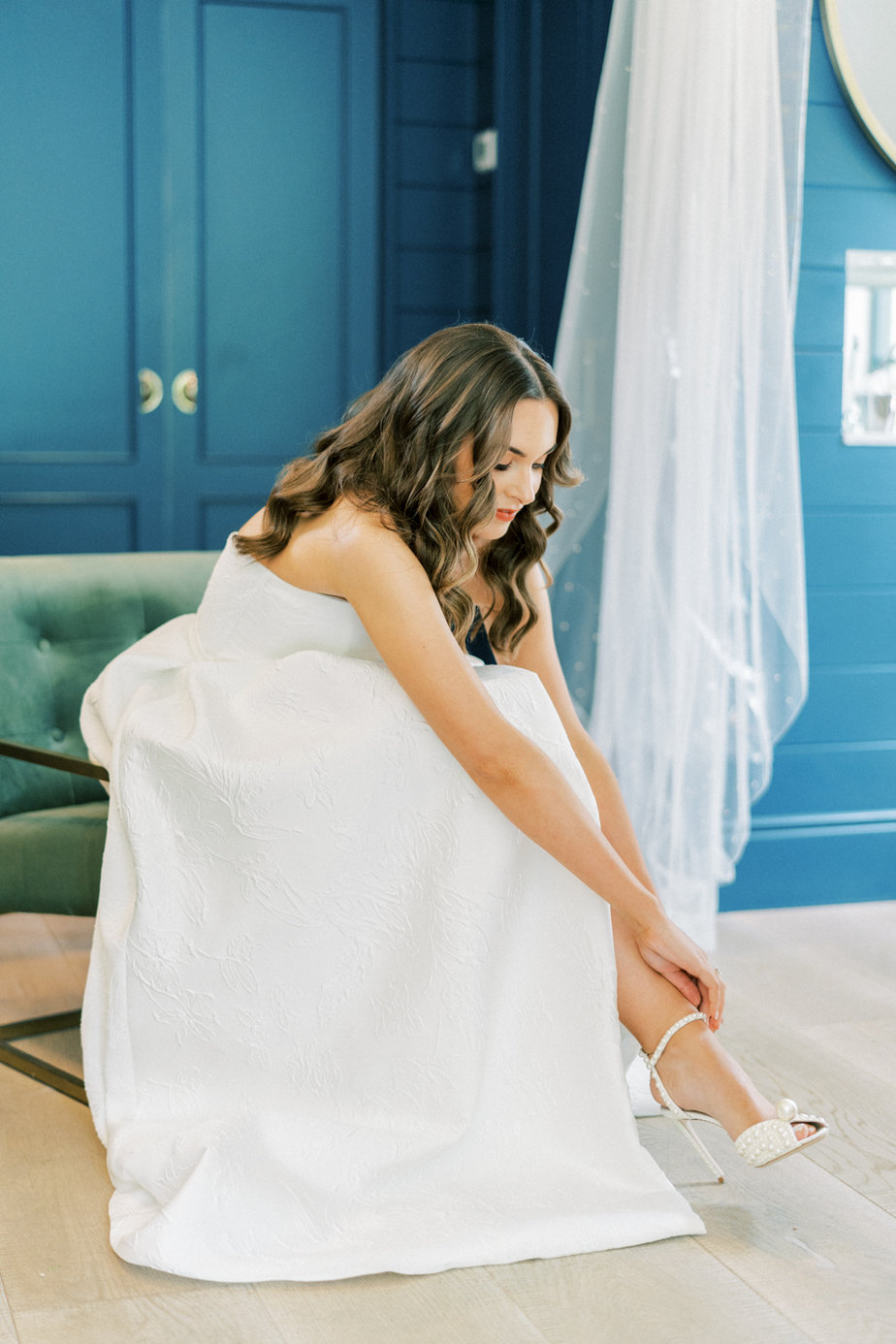 Bride putting on wedding shoes