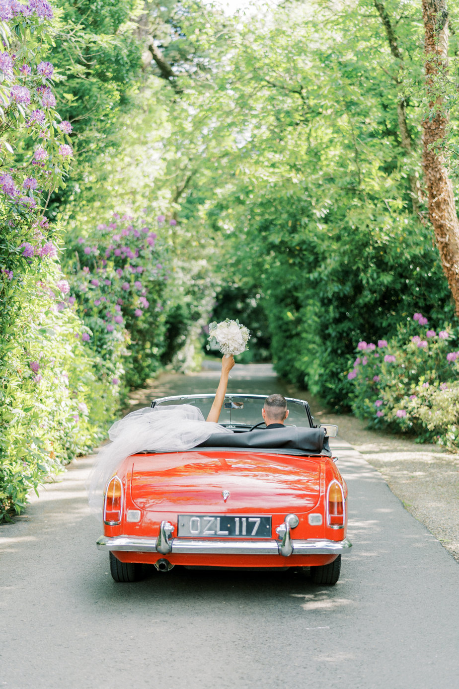 Just wed red wedding car bouquet of flowers bride groom