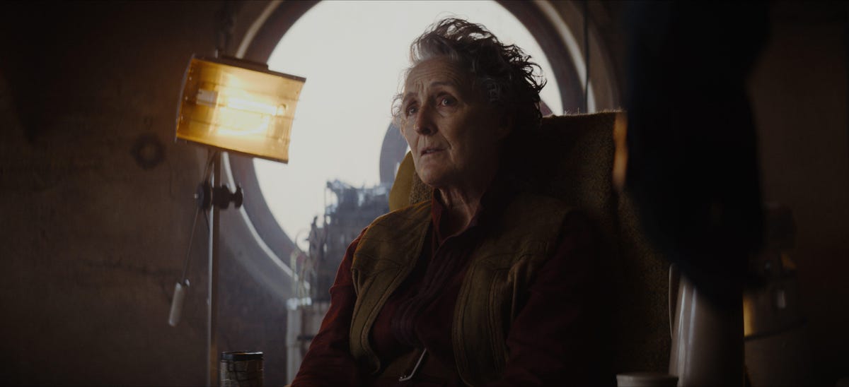 Maarva looks thoughtful as she sits next to a window in Andor