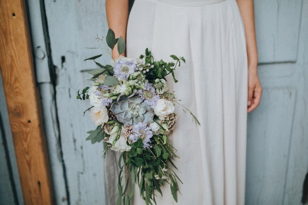 A bride holding a large bouquet. 