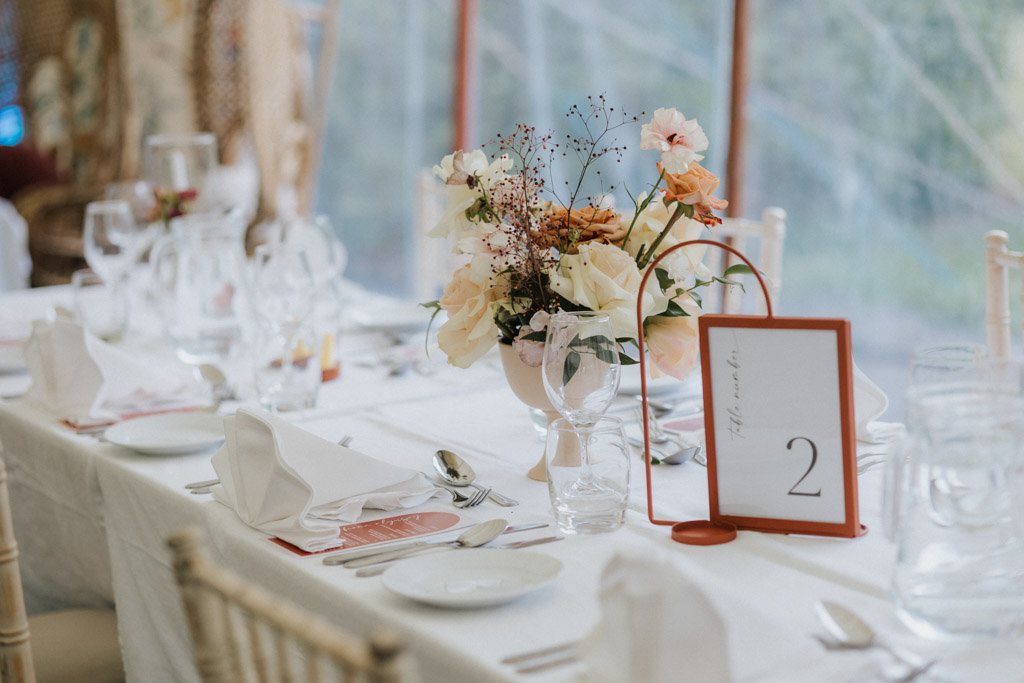White tablecloth setting dining room flowers chairs