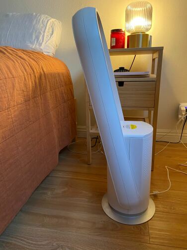 westinghouse fan tilted down next to bed and in front of nightstand 