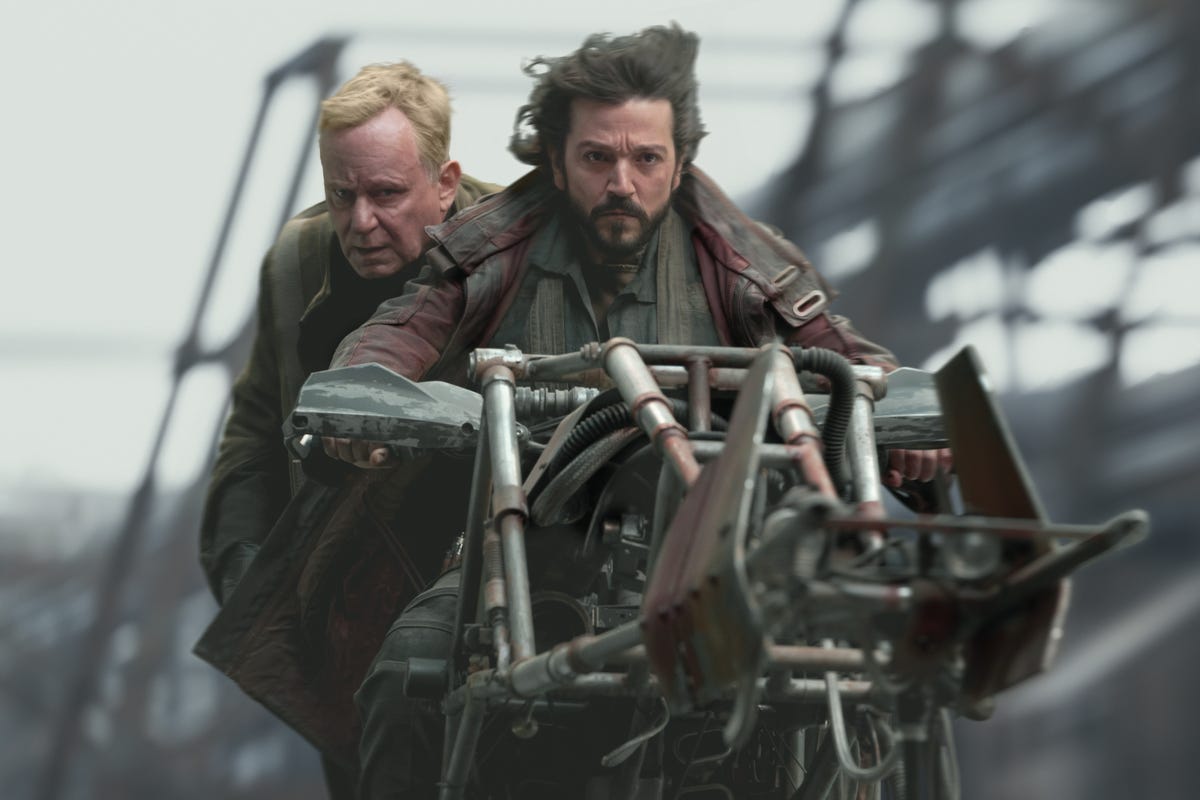 Luthen Rael and Cassian Andor flee on a speeder in Andor.