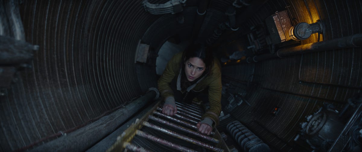 Bix Caleen looks concerned as she climbs a ladder in Andor