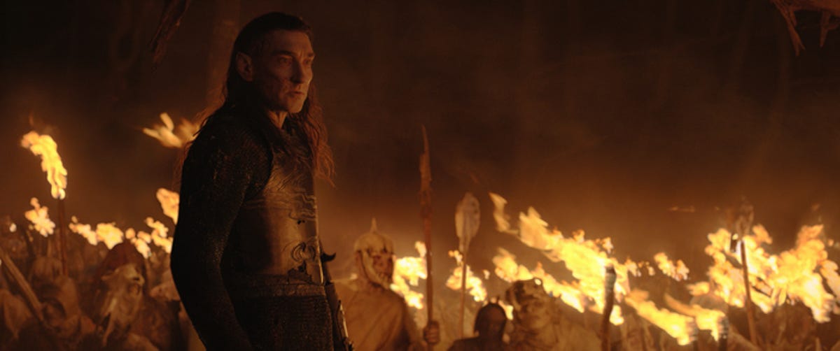 Adar and the orcs, holding torches.