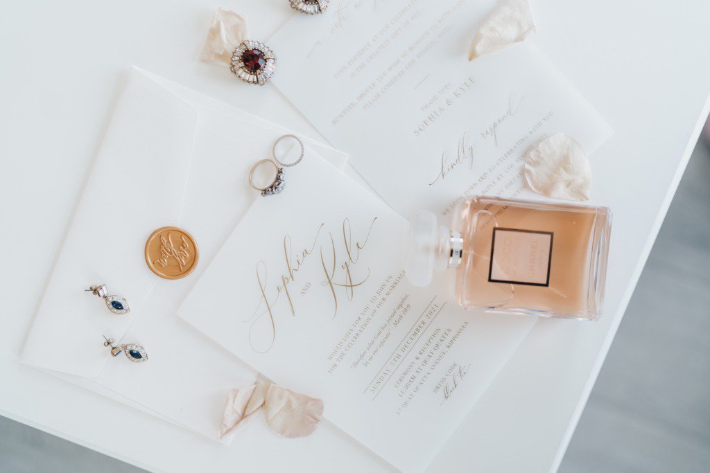 Two wedding rings bands coins letter and perfume