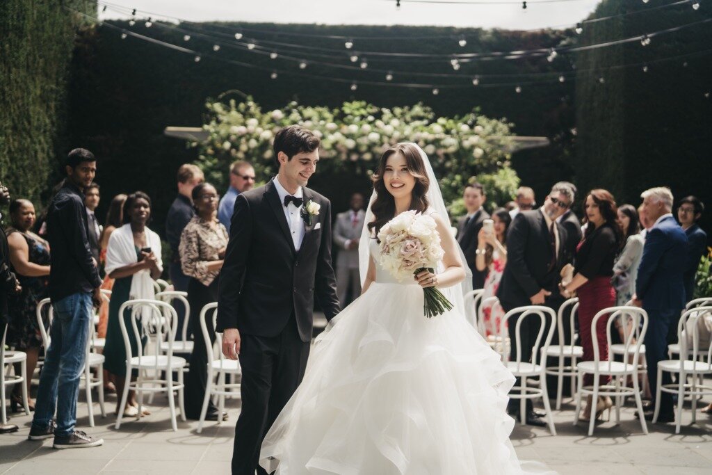 Bride and groom exit wedding ceremony hand in hand