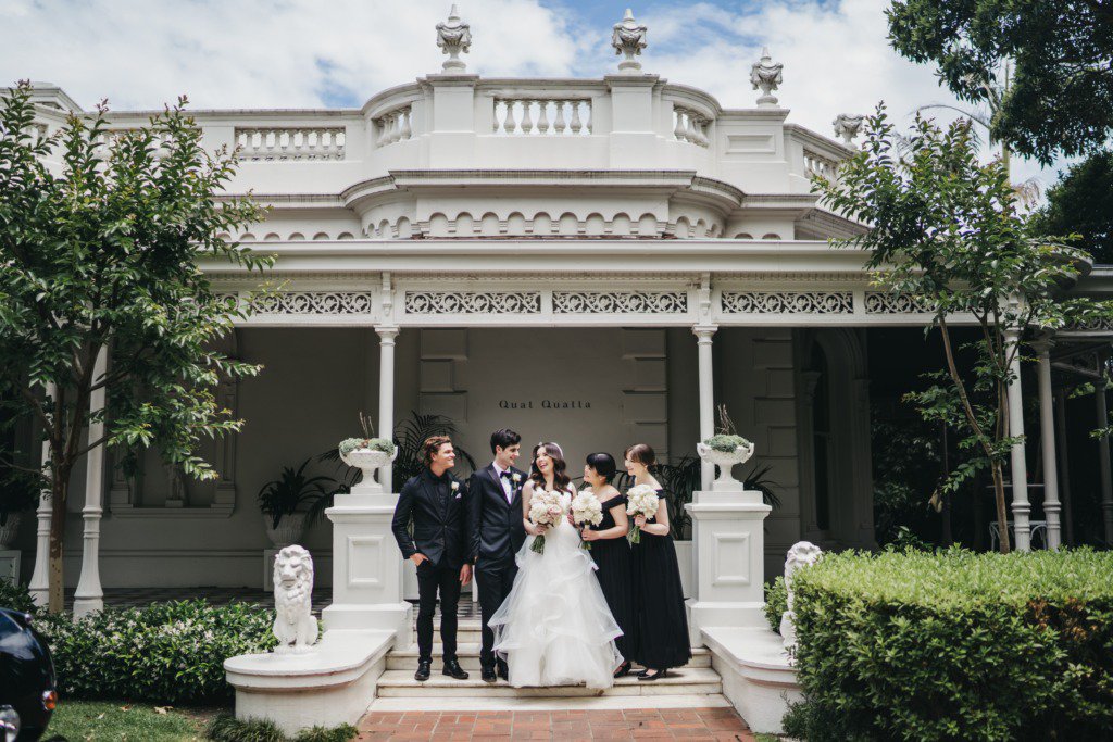 Bride bridesmaid groom and groomsman outside venue