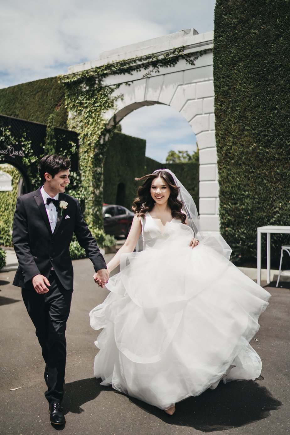 Bride and groom run walk hand in hand