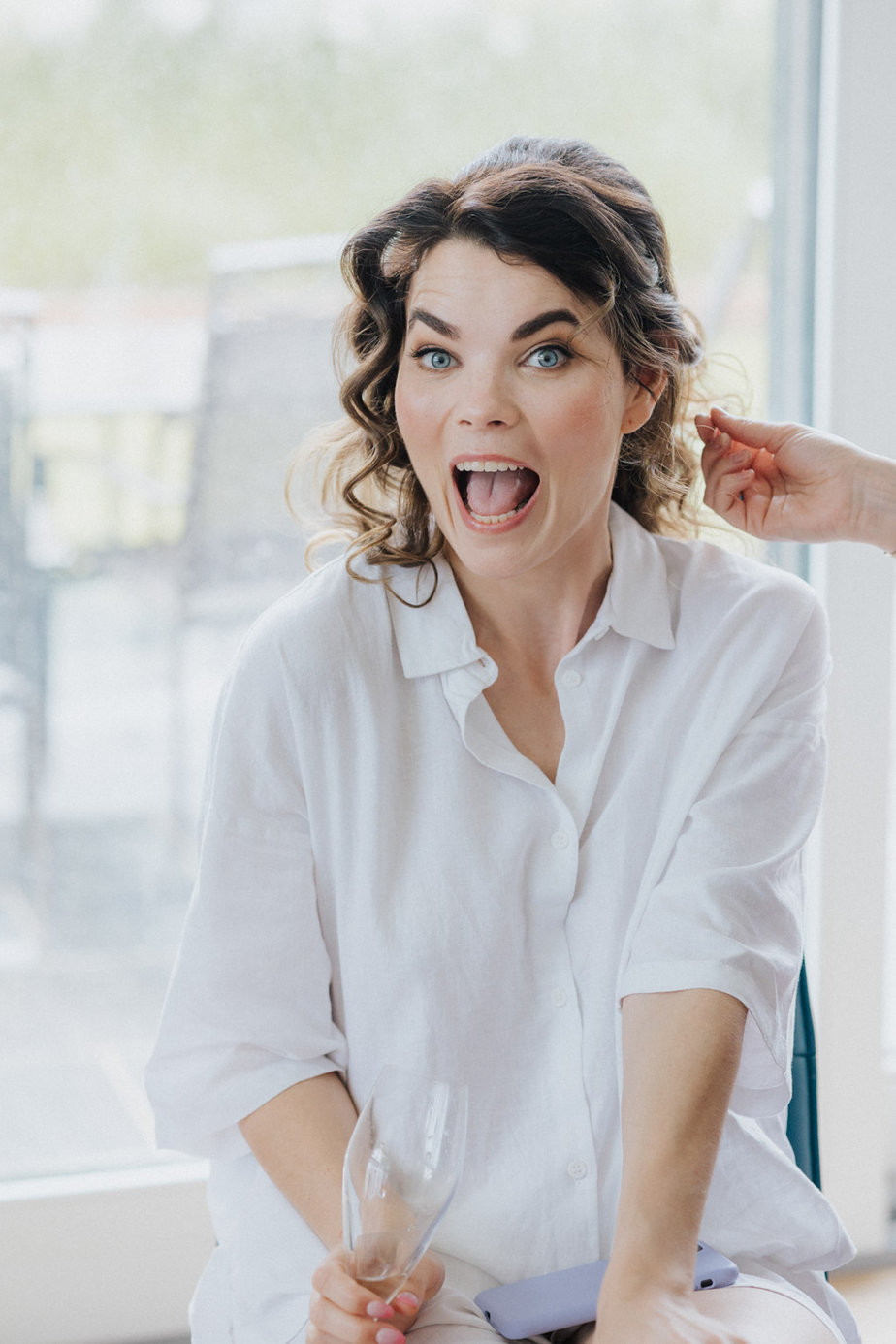 Surprised bride happy smiling getting ready hair stylist