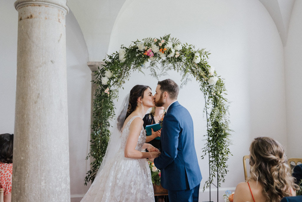 Bride and groom husband and wife kissing kiss holding hands