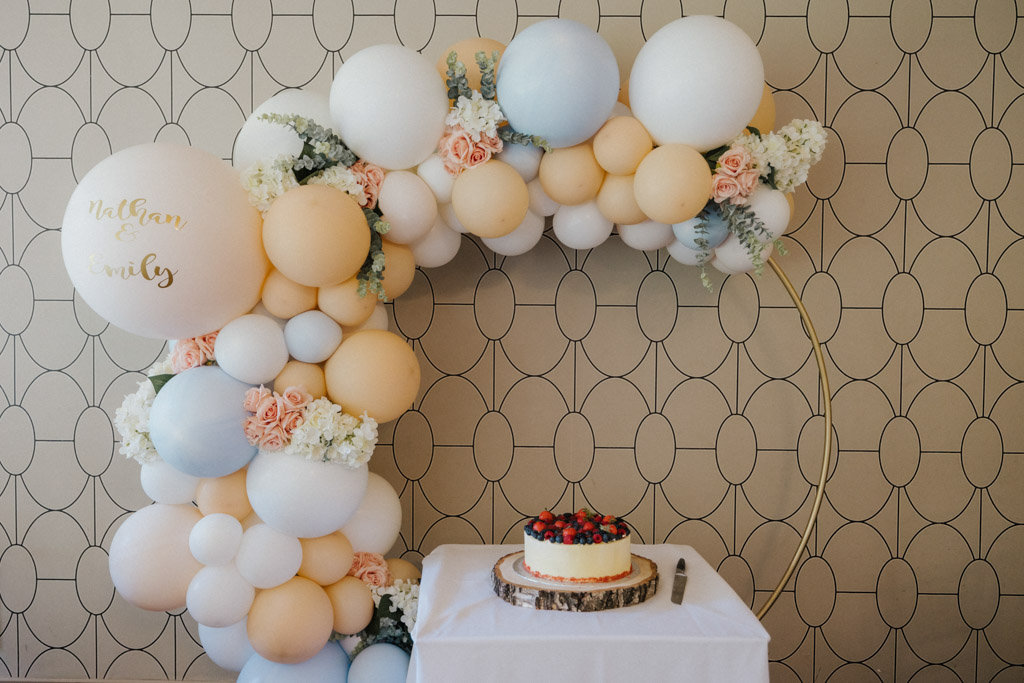 Strawberry fruit wedding cake pink and blue balloons in background