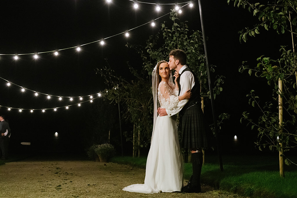 Nighttime shot of bride and groom lights