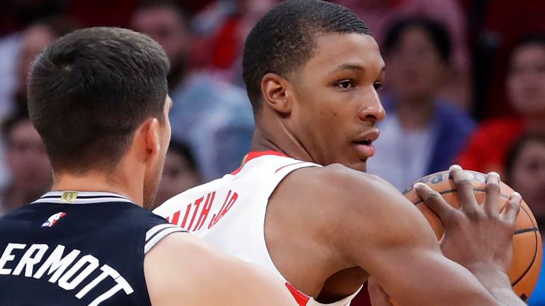 Houston Rockets forward Jabari Smith Jr., right, looks to pass the ball under pressure from San Antonio Spurs forward Doug McDermott (17) during the second half of an NBA preseason basketball game, Sunday, Oct. 2, 2022, in Houston. (AP Photo/Michael Wyke)
