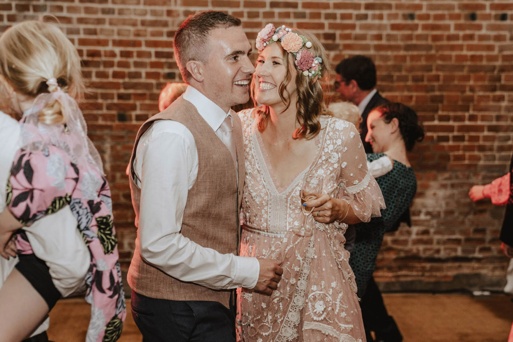 Happy smiling bride in Needle & Thread London wedding dress.