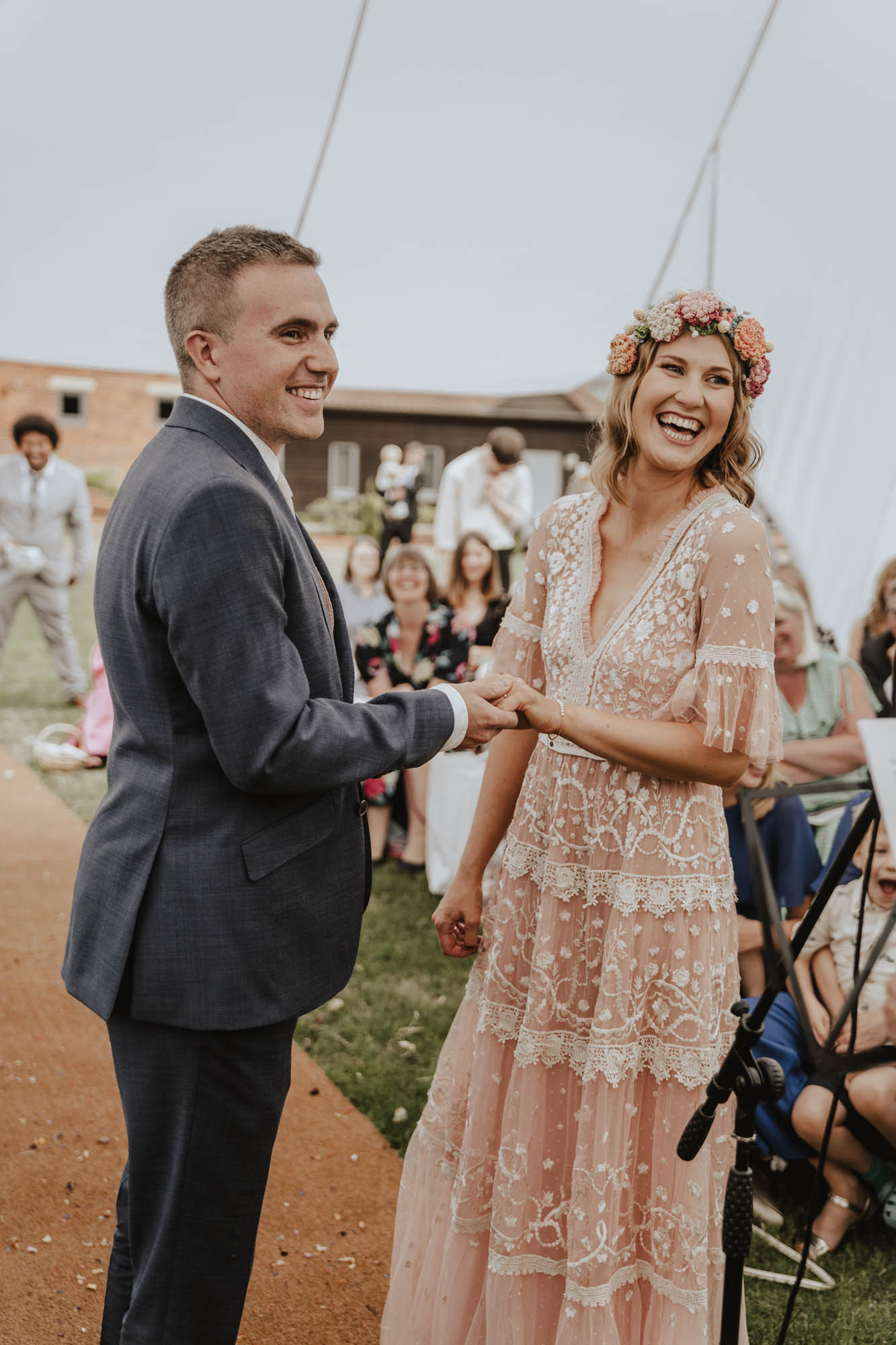 Bride wearing pink Needle & Thread wedding dress & crochet floral crown