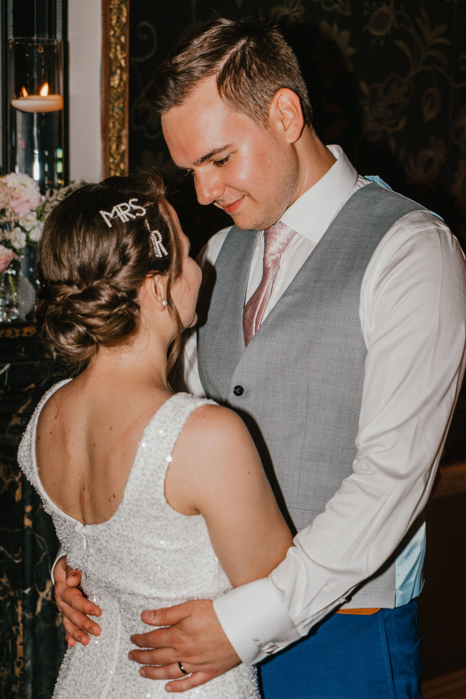 Bride & groom dancing, bride has Mrs hair clips in her hair. Shelby Ellis Photography.