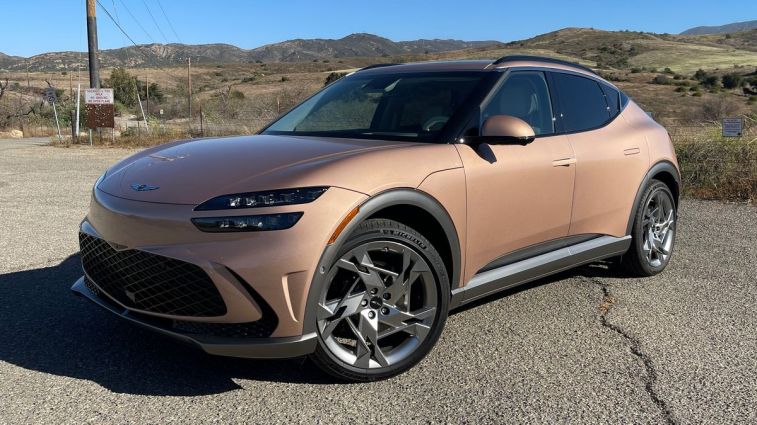 2024 Genesis GV60 with hills in the background.