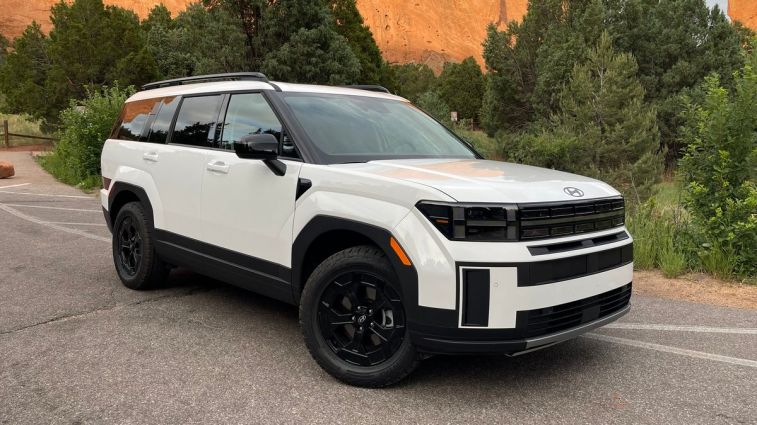 2024 Hyundai Santa Fe XRT in white with trees in the background.