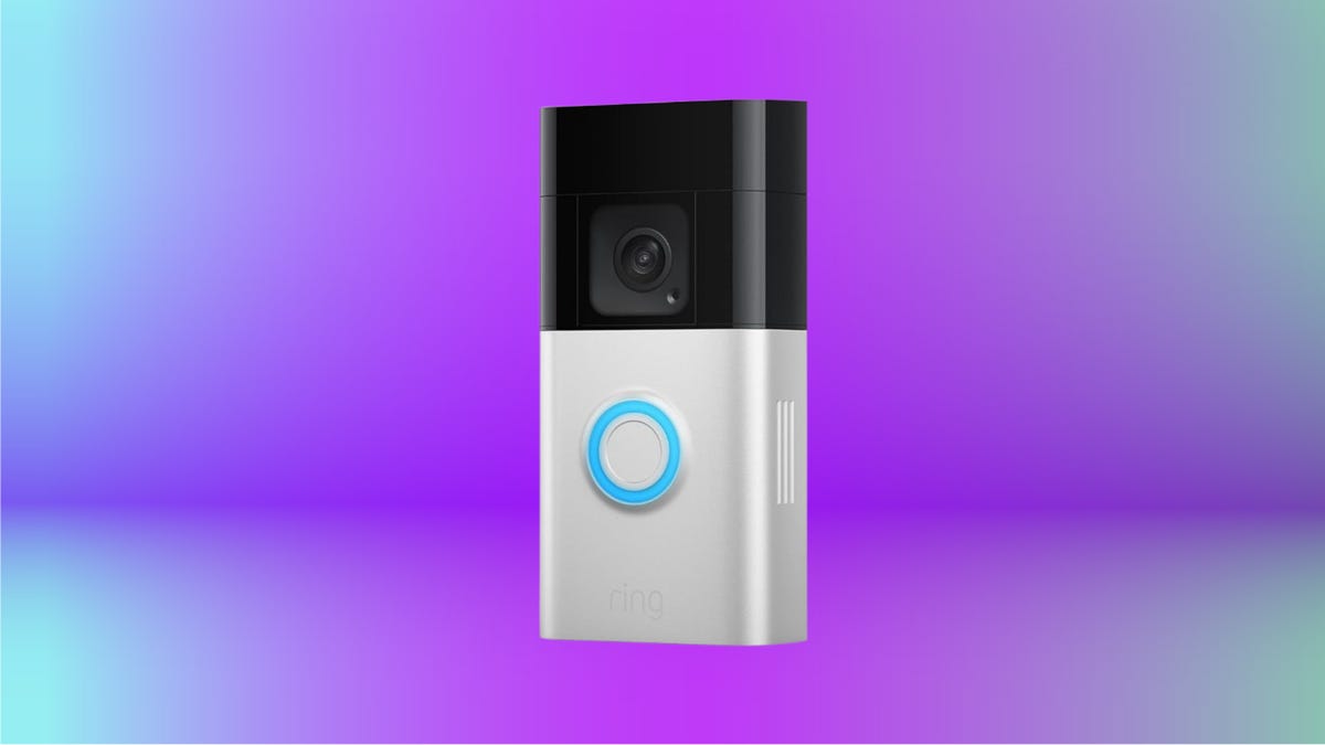 Silver camera with black accents against purple and blue gradient