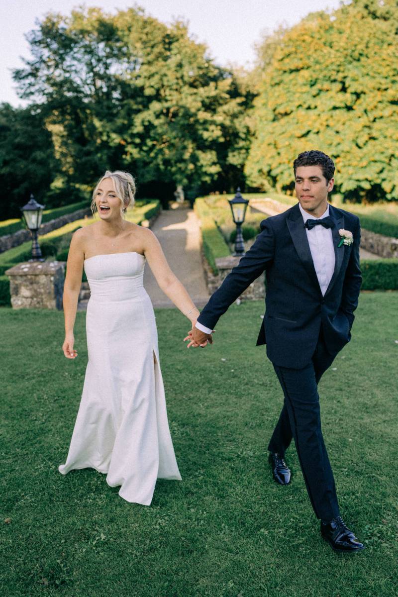Bride and groom walk in garden during Virginia Park Lodge wedding