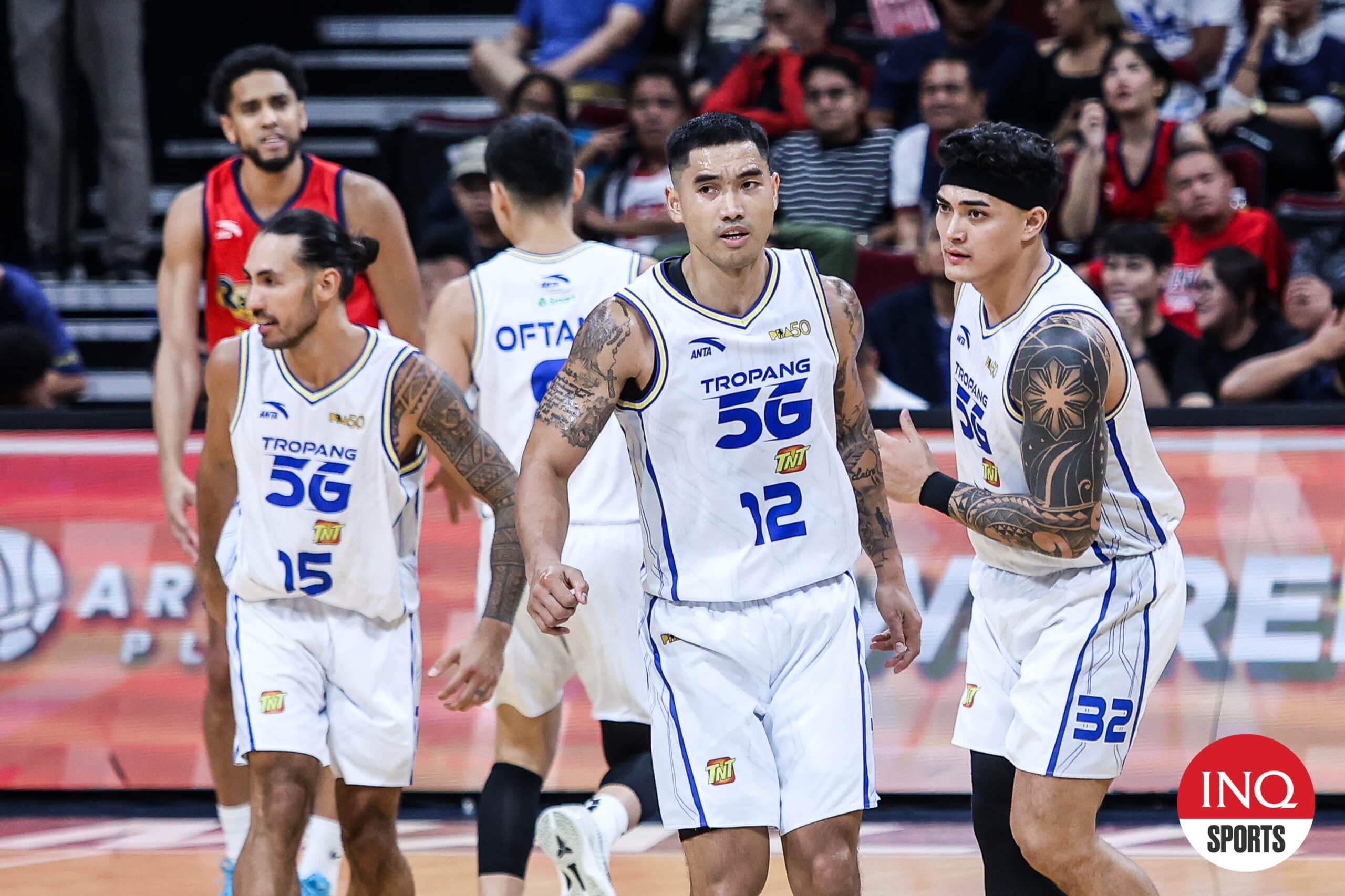 TNT Tropang Giga's Jordan Heading, Glenn Khobuntin, and Henry Galinato Jr. during the PBA Philippine Cup semifinals Game 3 against Rain or Shine Elasto Painters.