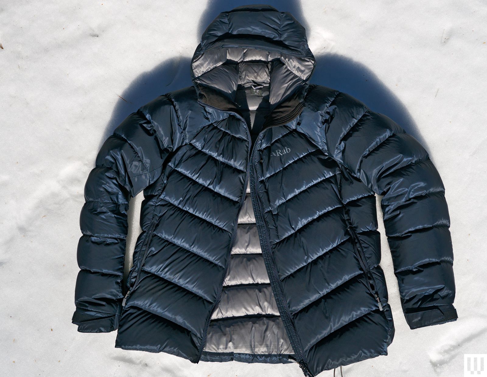 Overhead view of Rab Glaceon Pro Down Jacket in blue laying in snow
