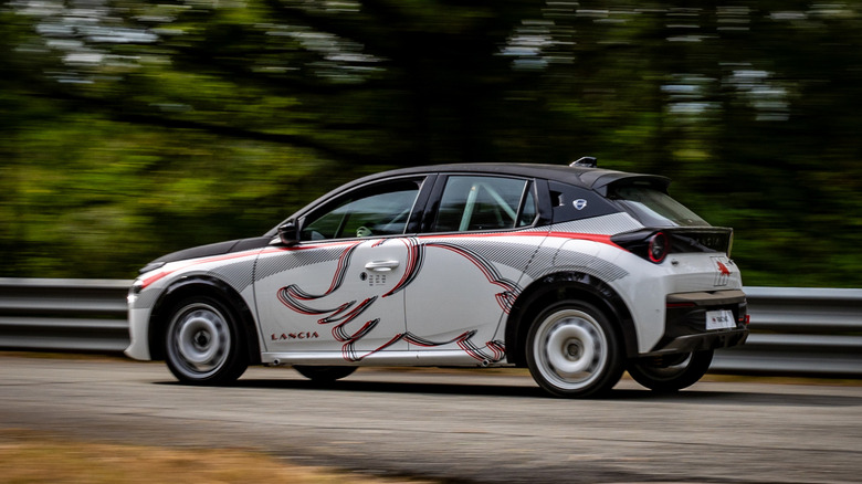 Side view of a white Lancia Ypsilon HF Racing in motion