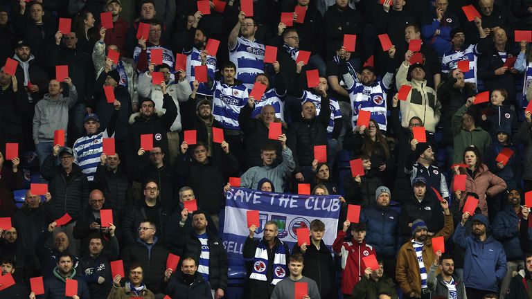 Reading fans hold up red cards in protest against owner Dai Yongge