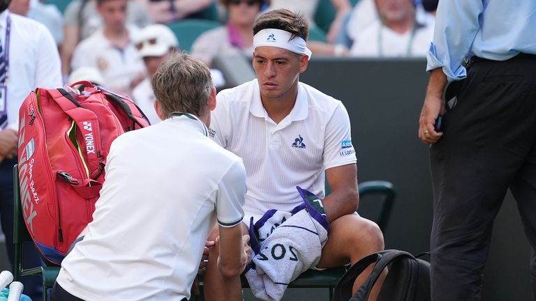 Sebastian Baez receives treatment during a medical time out during his match against Jack Draper at Wimbledon