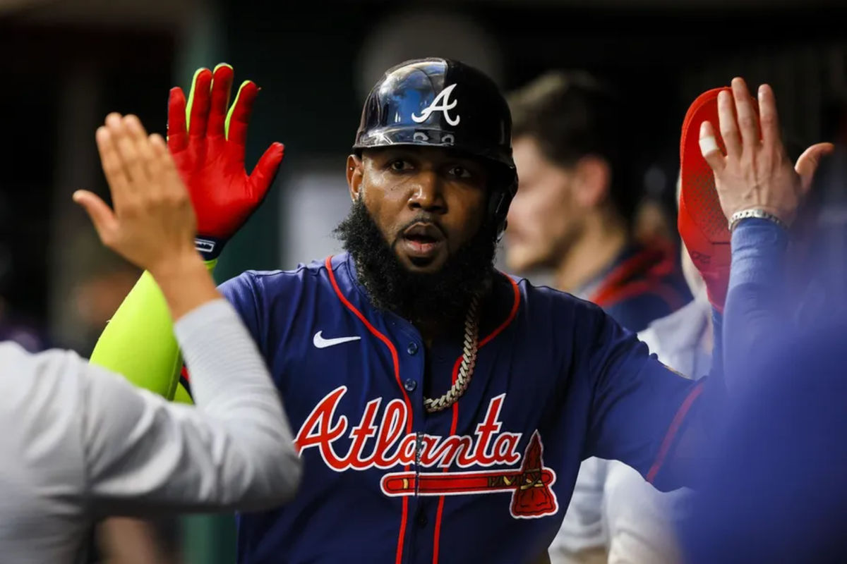 Sep 18, 2024; Cincinnati, Ohio, USA; Atlanta Braves designated hitter Marcell Ozuna (20) high fives teammates after scoring on a RBI single hit by first baseman Matt Olson (not pictured) in the fourth inning against the Cincinnati Reds at Great American Ball Park. Mandatory Credit: Katie Stratman-Imagn Images
