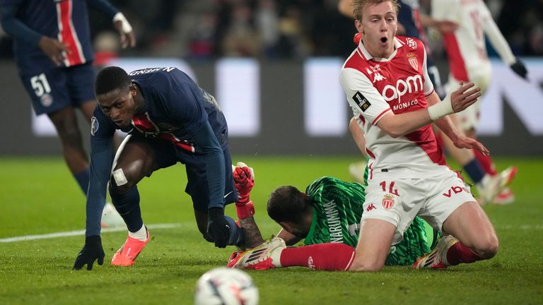 PSG's Nuno Mendes watches as Monaco's Mika Biereth clashes with Gianluigi Donnarumma