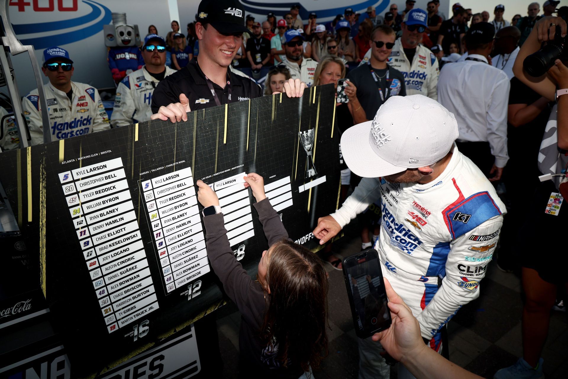 Kyle Larson's daughter, Audrey, places his name on the 2024 Playoffs Grid. Source: Getty