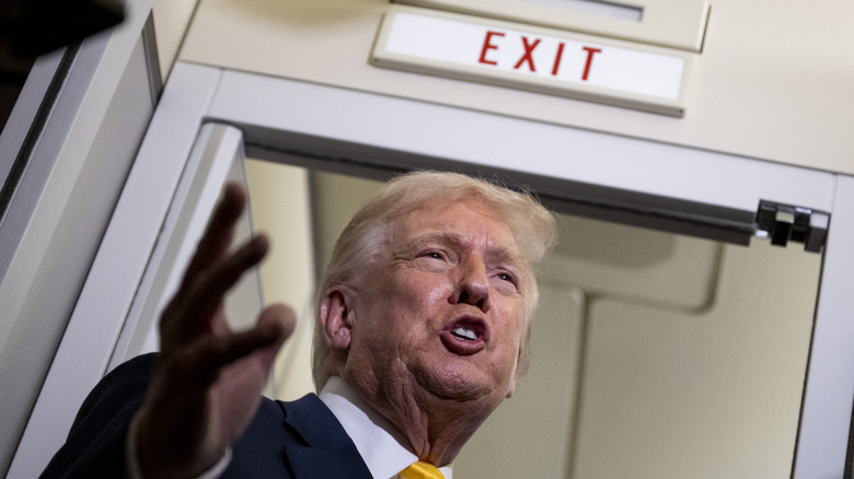 President Donald Trump speaks to members of press aboard Air Force One on November 14, 2025 while in flight from Washington, DC to West Palm Beach International Airport.