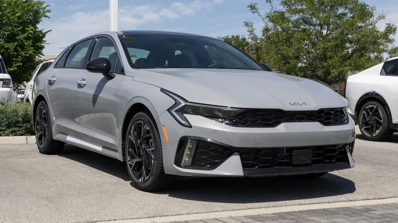 Kia K5 GT-Line AWD sedan display at a dealership.