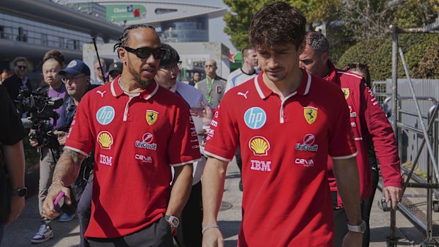 Ferrari driver Lewis Hamilton of Britain, left, chats with his teammate Charles Leclerc of Monaco as they walk out from their team's hospitality suite ahead of the Chinese Formula One Grand Prix, in Shanghai, China, Friday, March 21, 2025. (AP Photo/Andy Wong)