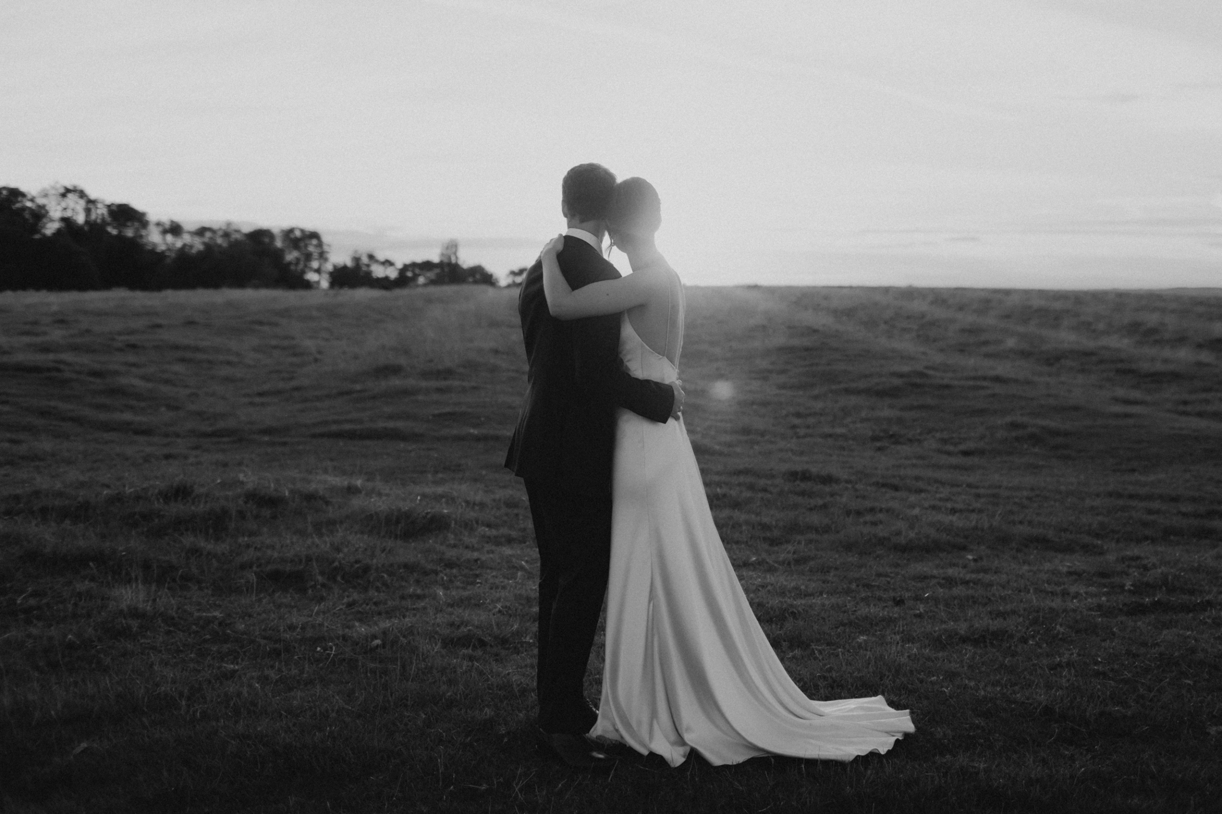 Stillness. 5 Stillness. A beautiful black and white wedding photography of a couple staring into the distance during sunset. Victoria Somerset How Photography.