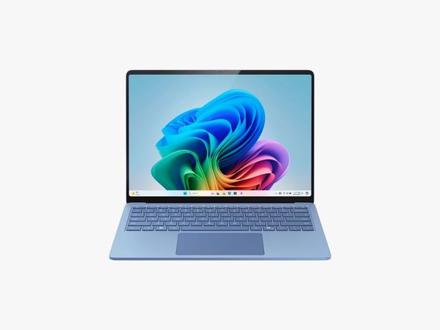Front view of light blue laptop opened with abstract art on the screen