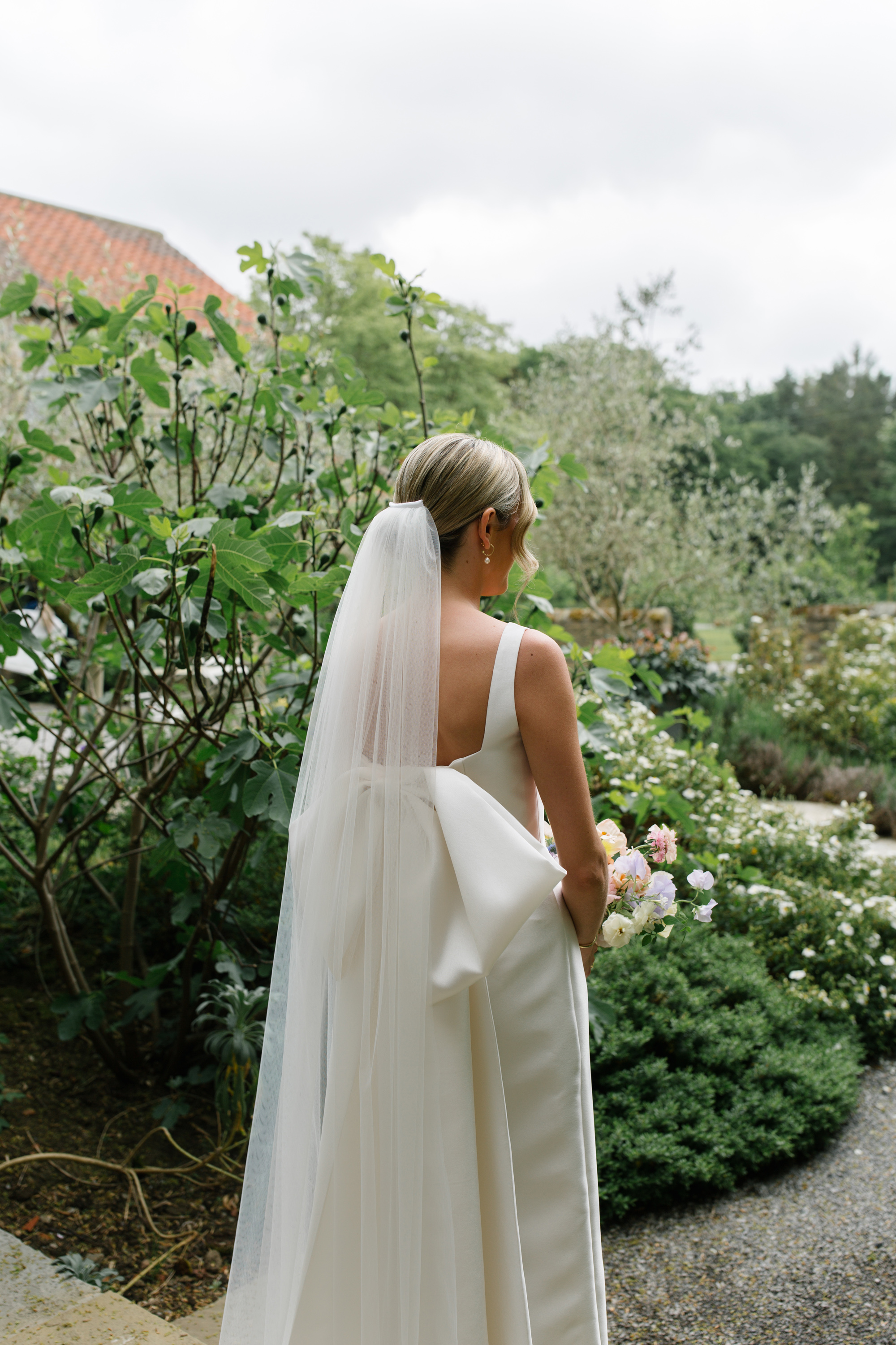 Maisie Wore Jessica Bennett for Her Spring Pastel Flower Filled Wedding at Middleton Lodge 32 Bride wearing a Jessica Bennet wedding dress with large bow at the back.
