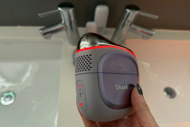 Leah's hand holding Shark Depuffi handheld device on heat mode