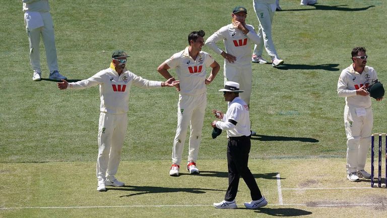 Nathan Lyon and Pat Cummins show their frustration after a decision to dismiss Jamie Smith is overturned by the third umpire