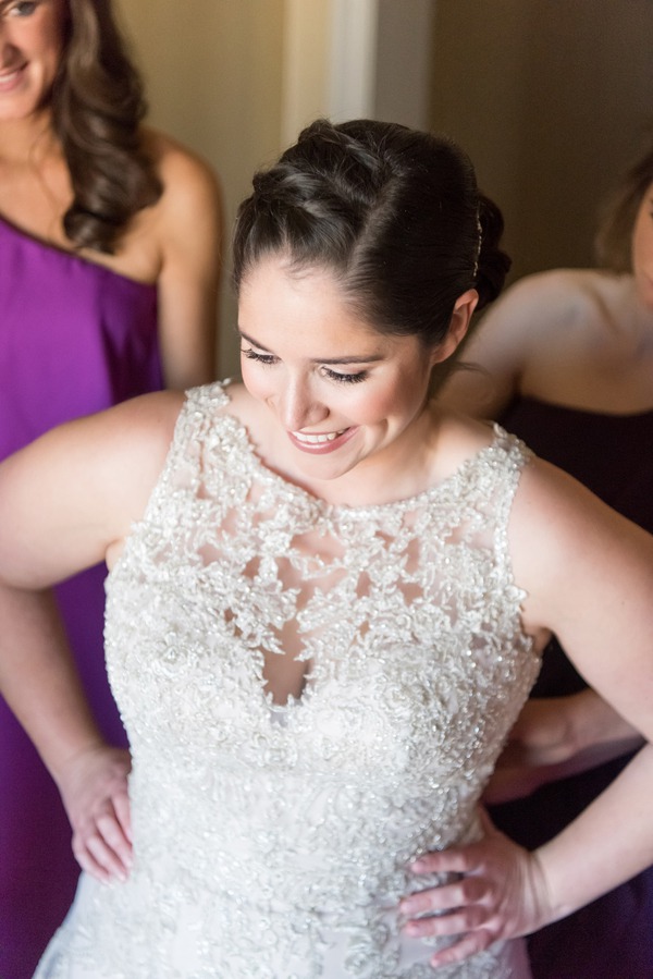 Close-up detail shot of a heavily beaded illusion lace bodice on a plus-size bride during getting-ready at a rustic ranch wedding