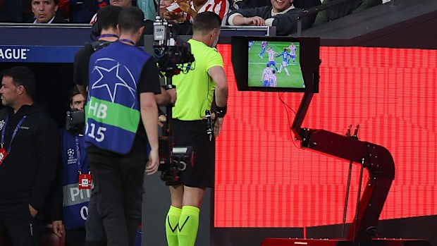 Referee Danny Makkelie looks at VAR.