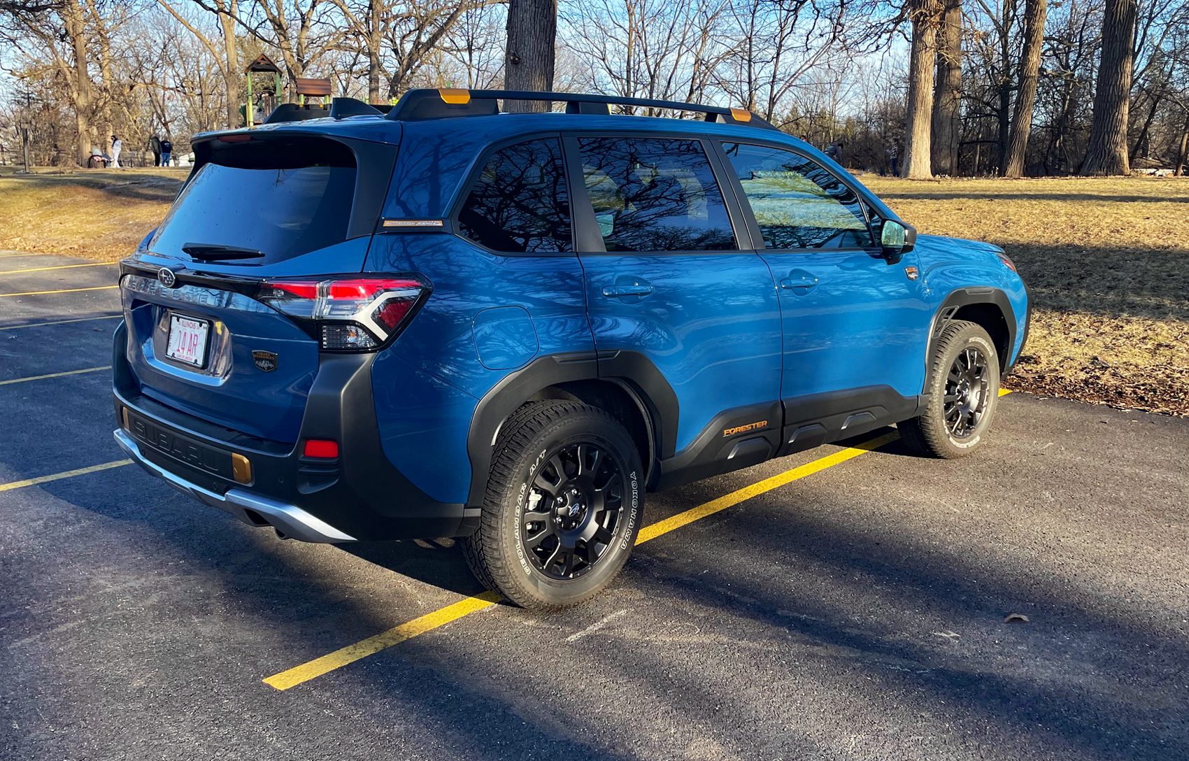 2026 Subaru Forester Wilderness in Geyser Blue, rear 3/4 view, trees