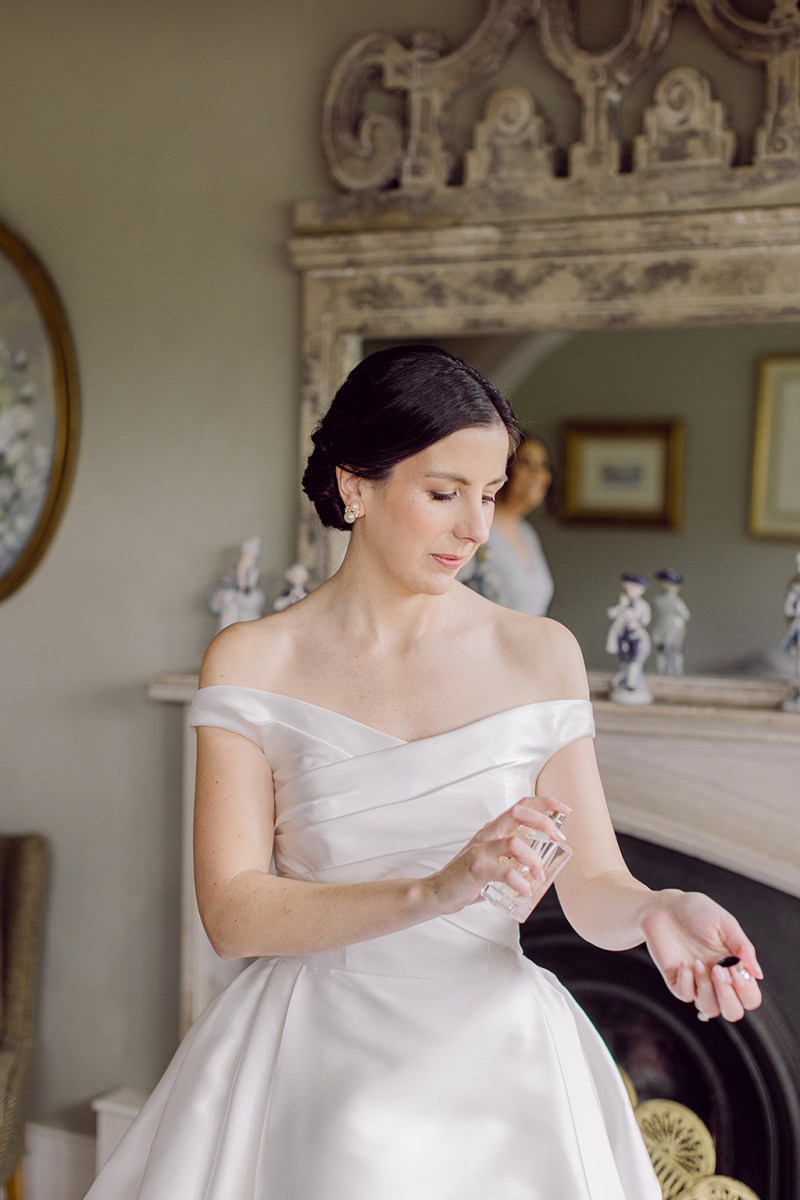 Bride sprays perfume during her spring castle wedding