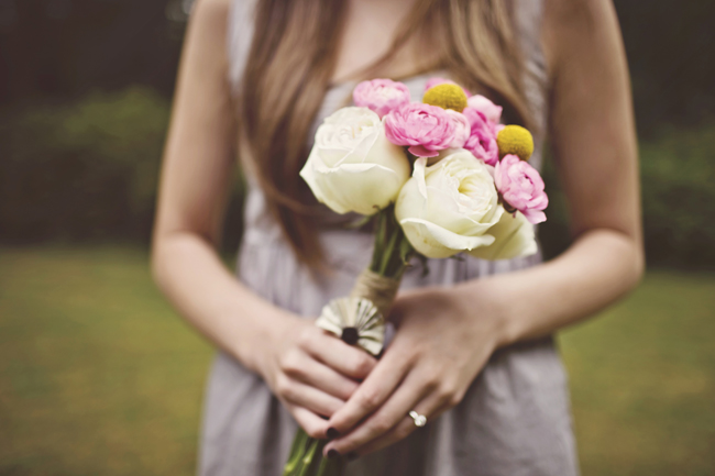 Small bouquet of pink ranunculus, white roses and yellow craspedia